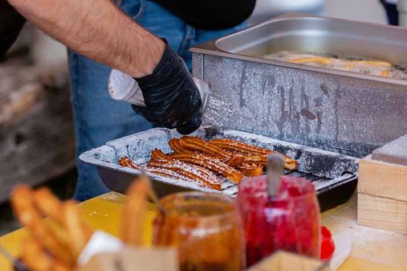 vendor preparing churros for Ferry Building food tour